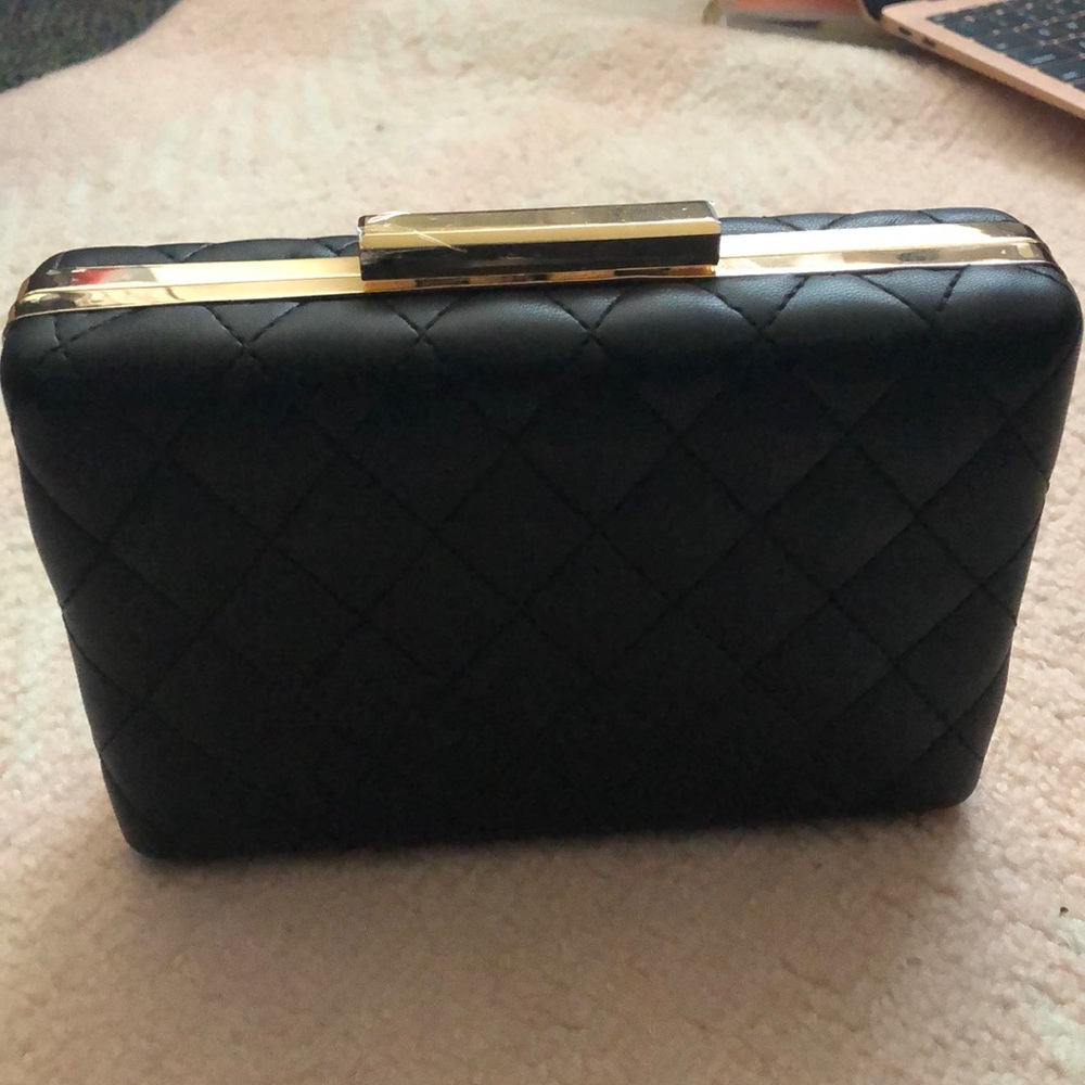 A black with gold detailing clutch